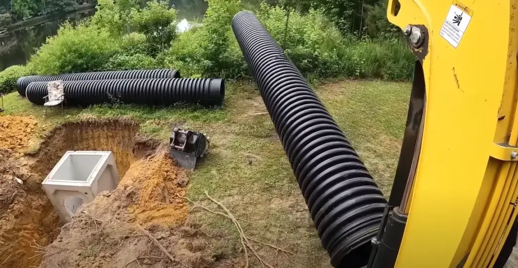 16-inch-corrugated-abs-drain-pipe-being-connected-to-concrete-catch-basin-invert-in