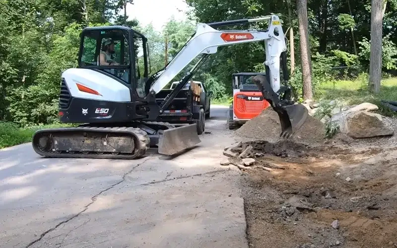 e-50-model-bobcat-mini-excavator-roughing-in-new-gravel-driveway-for-custom-home-builder-in-new-haven-county