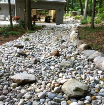 pitched-man-river-rock-made-stone-swale-for-water-movement