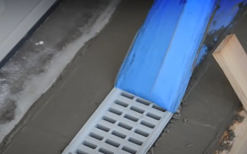 removing-protective-tape-from-slot-drain-sfter-pouring-concrete